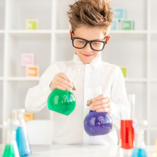 Little boy studying chemistry in lab