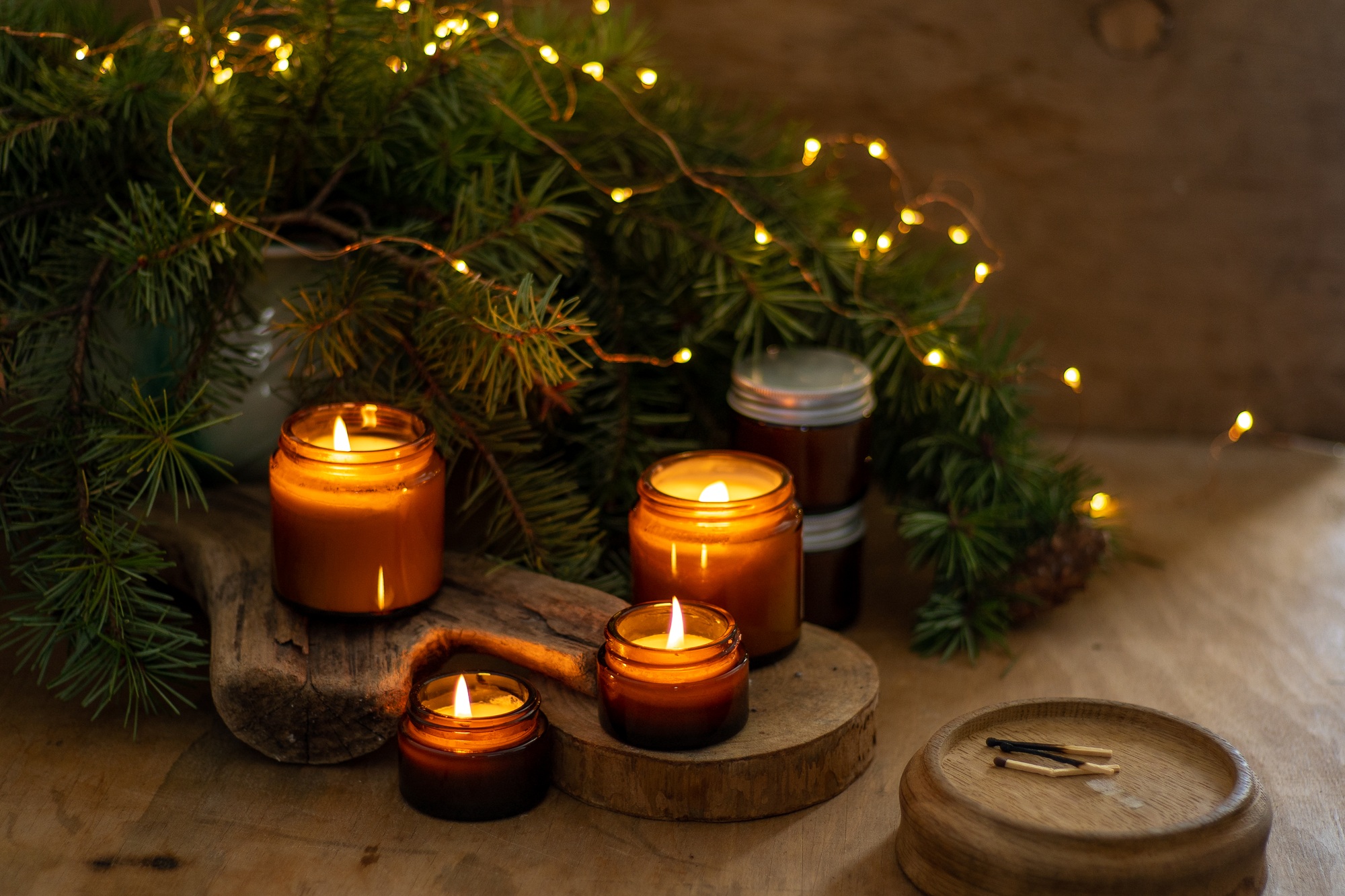 Soy candles burn in glass jars. The evening is dark. Aromatherapy and relaxation. Comfort at home